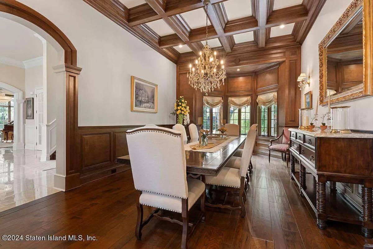 Admire the Coffered Ceiling and Crystal Chandelier in This Dining Room