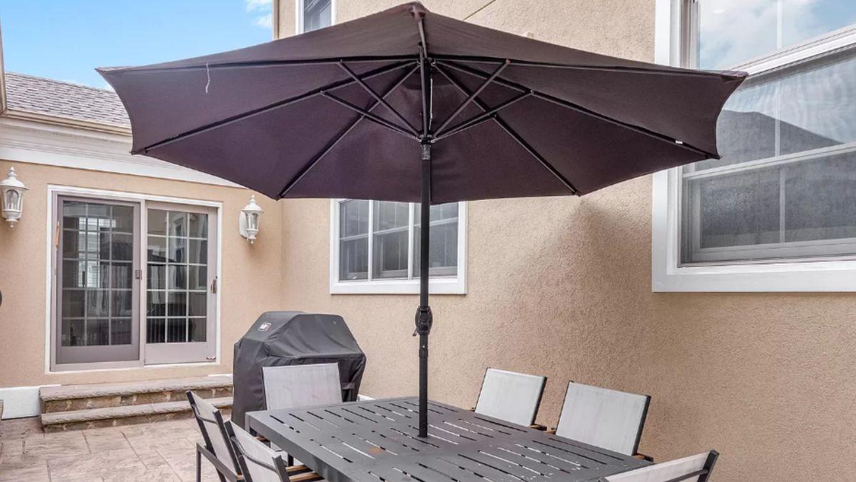 Patio Dining Setup with a Broad Umbrella for All-Weather Comfort