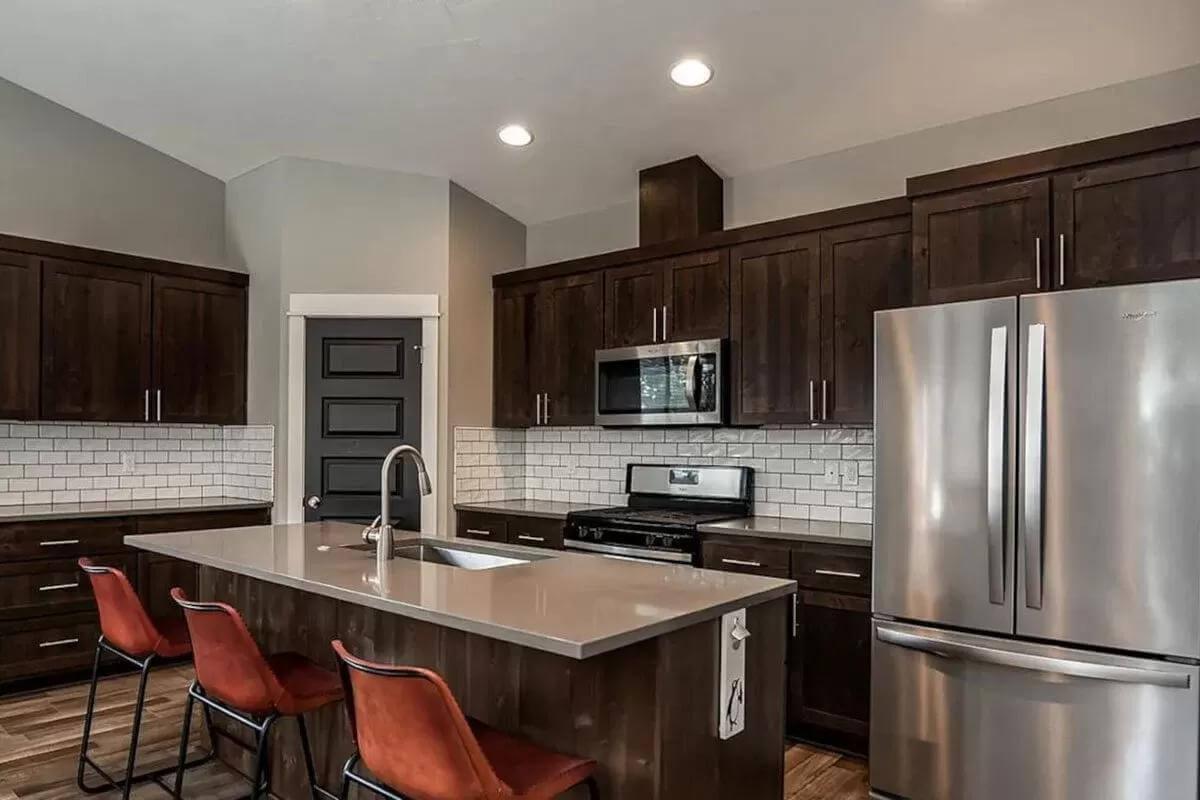 Modern Kitchen with Striking Dark Cabinets and Subway Tile