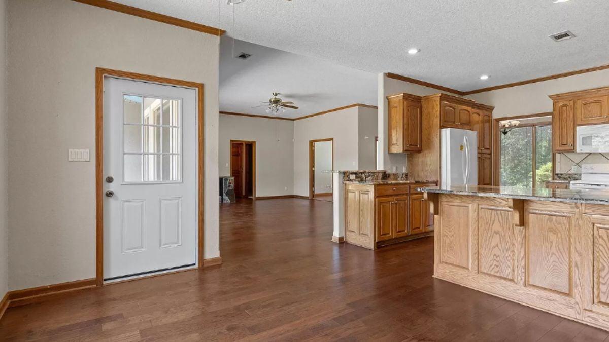 Open-Plan Kitchen with Rich Wood Accents and Granite Countertops