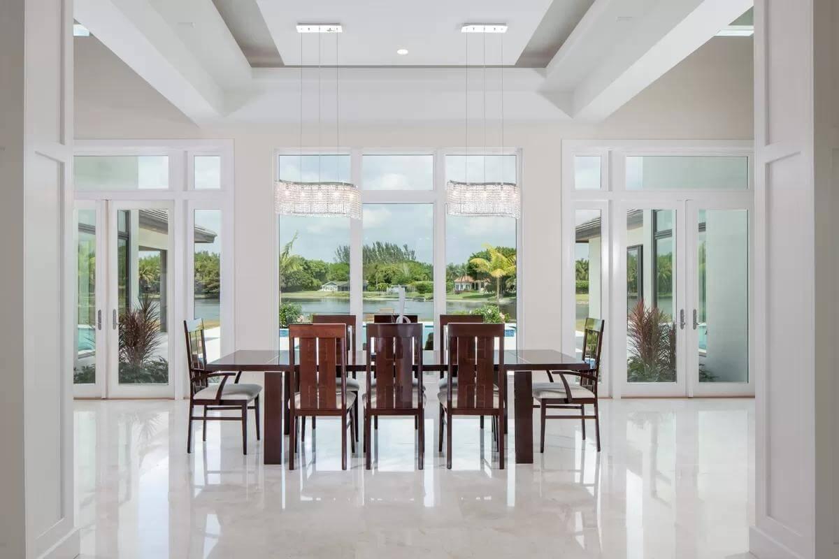 Dining Room Delight with Stunning Lake Views and Bold Pendant Lights