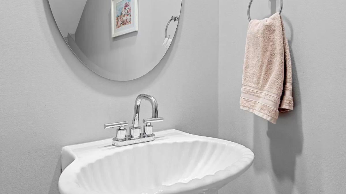Check Out the Stylish Shell Basin in This Powder Room