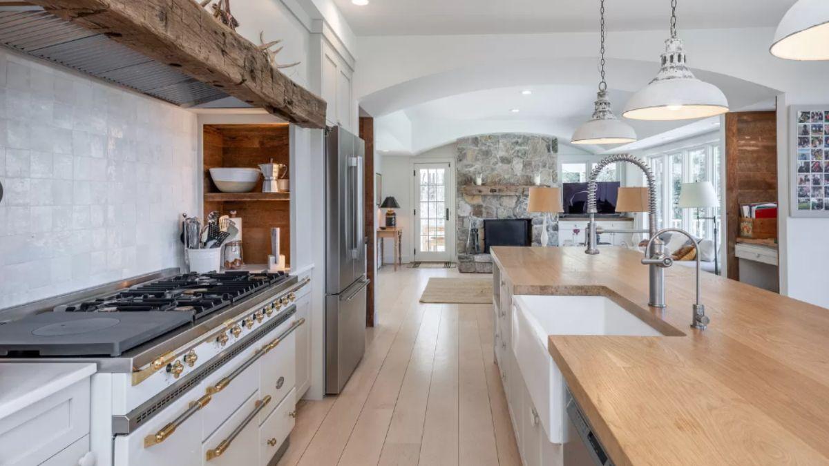Notice the Rustic Range Hood and Farmhouse Sink in This Cozy Craftsman Kitchen