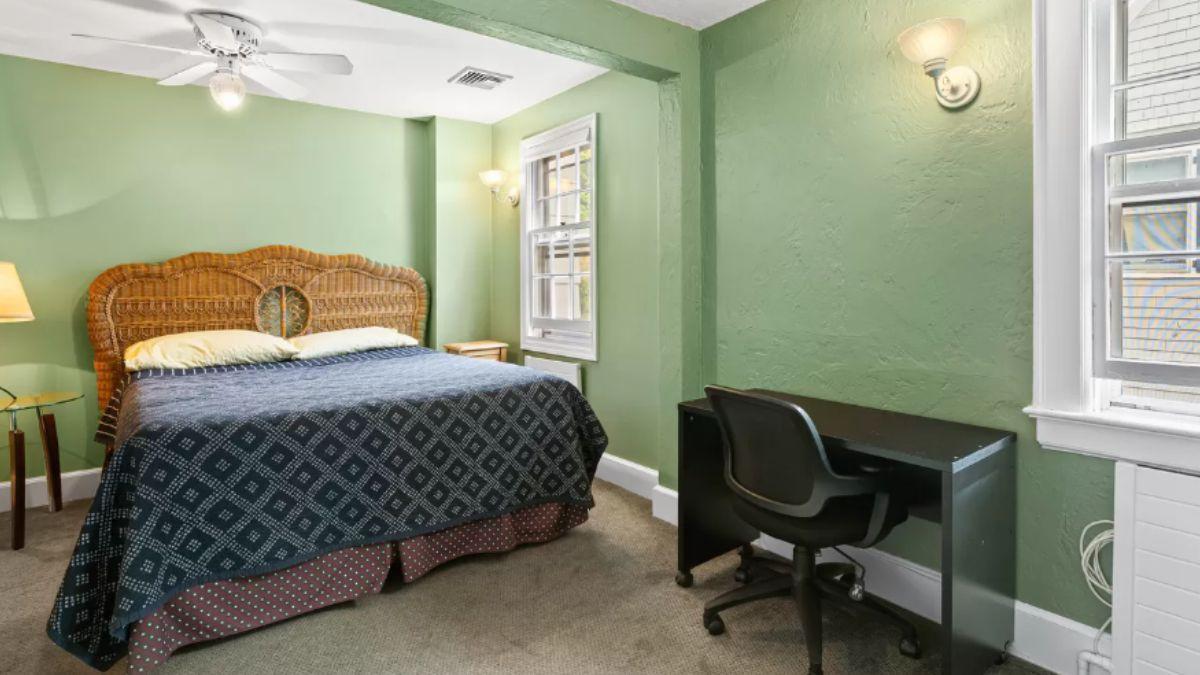 Cozy Bedroom with a Woven Headboard and Functional Workspace