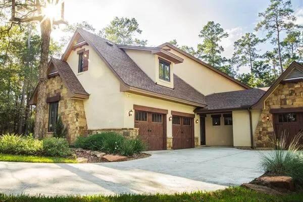 Admire the Charming Stone Accents on This Craftsman-Inspired Garage