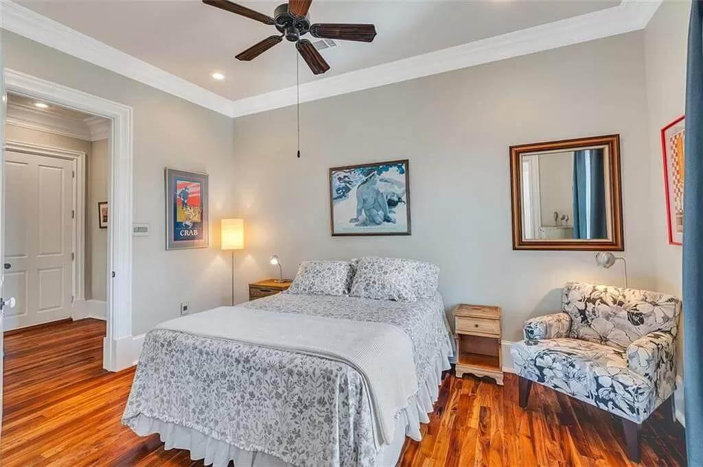 Cozy Bedroom with Rich Wood Floors and Floral Accents