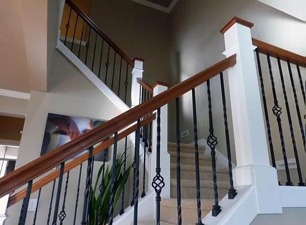 Check Out the Elegant Staircase with Detailed Iron Balusters
