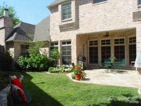 Charming Brick Patio Space with Verdant Garden
