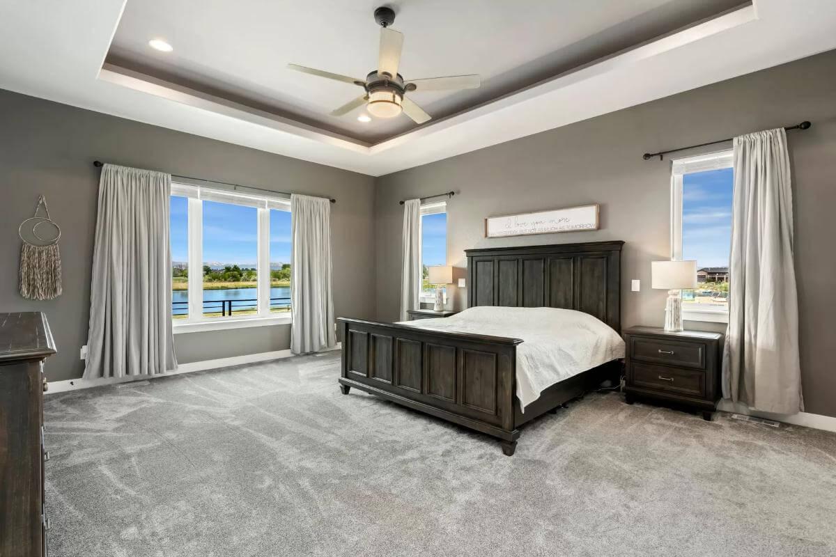 Peaceful Main Bedroom with Soft Gray Tones and Lake Views