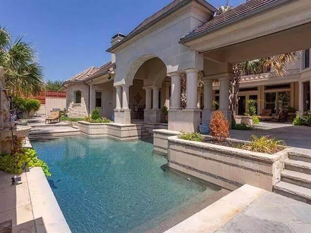Admire the Expansive Arched Patio Overlooking a Tranquil Pool