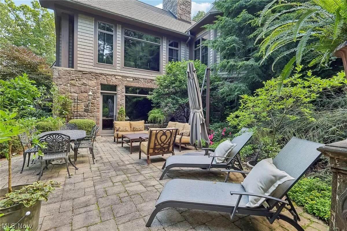 Charming Patio with Stone Details and Lush Greenery