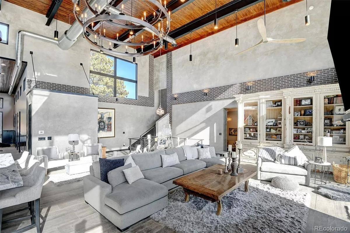 Industrial Living Room with Dramatic Soaring Ceilings and Rustic Touches