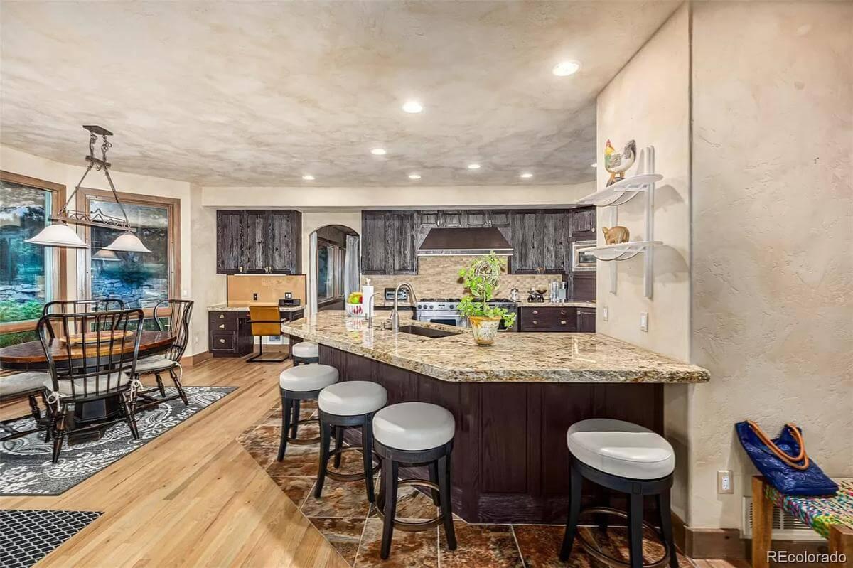 Notice the Expansive Granite Island in This Craftsman Kitchen