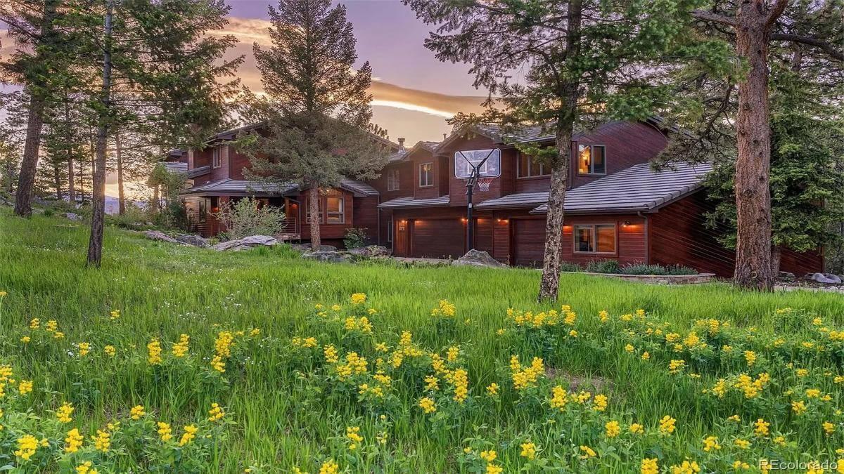 Mountain Retreat with Warm Wood Siding Surrounded by Wildflowers
