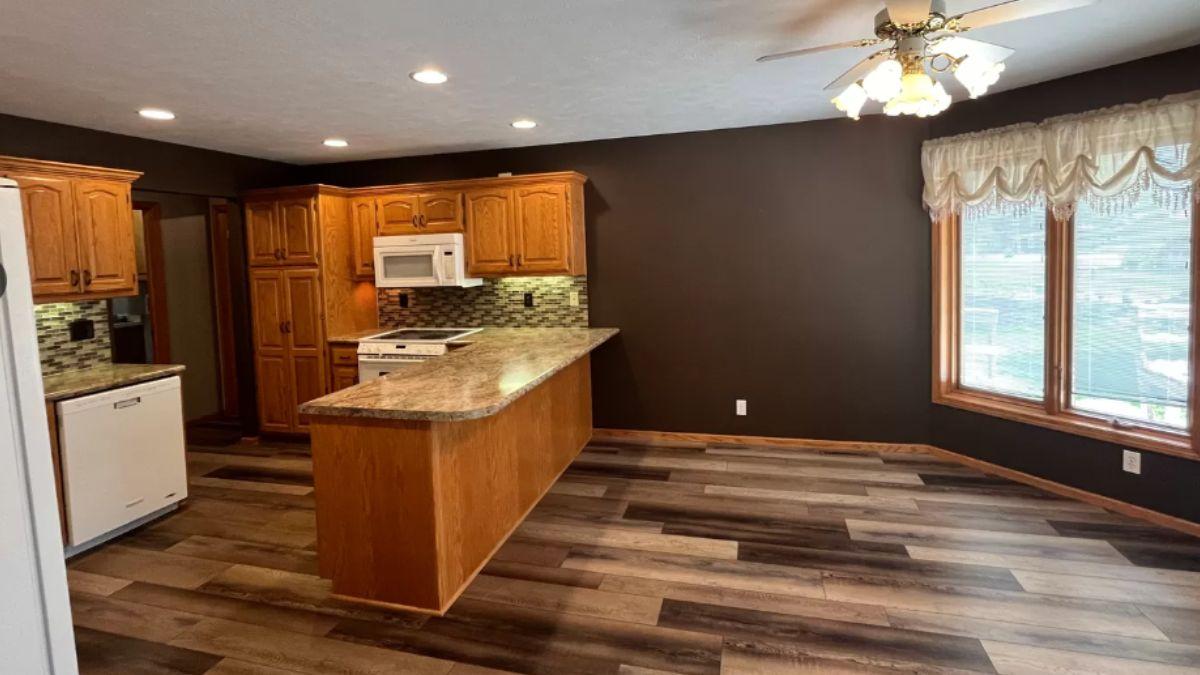 Classic Kitchen with Warm Wood Cabinetry and a Bold Accent Wall