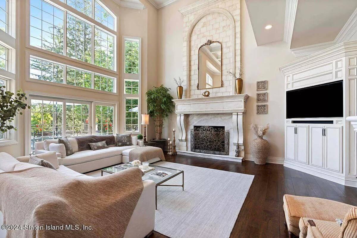 Notice the Soaring Windows and Elegant Fireplace in This Living Room