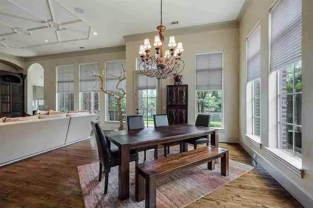 Relaxed Dining Area with Rustic Bench Seating and Elegant Chandelier