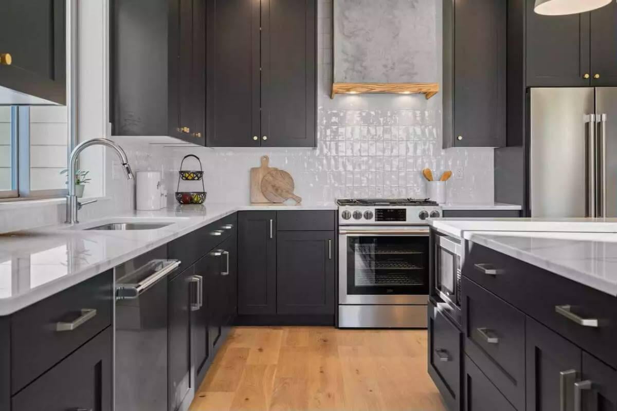 Check Out the Impact of Dark Cabinetry with Bright Countertops in This Kitchen