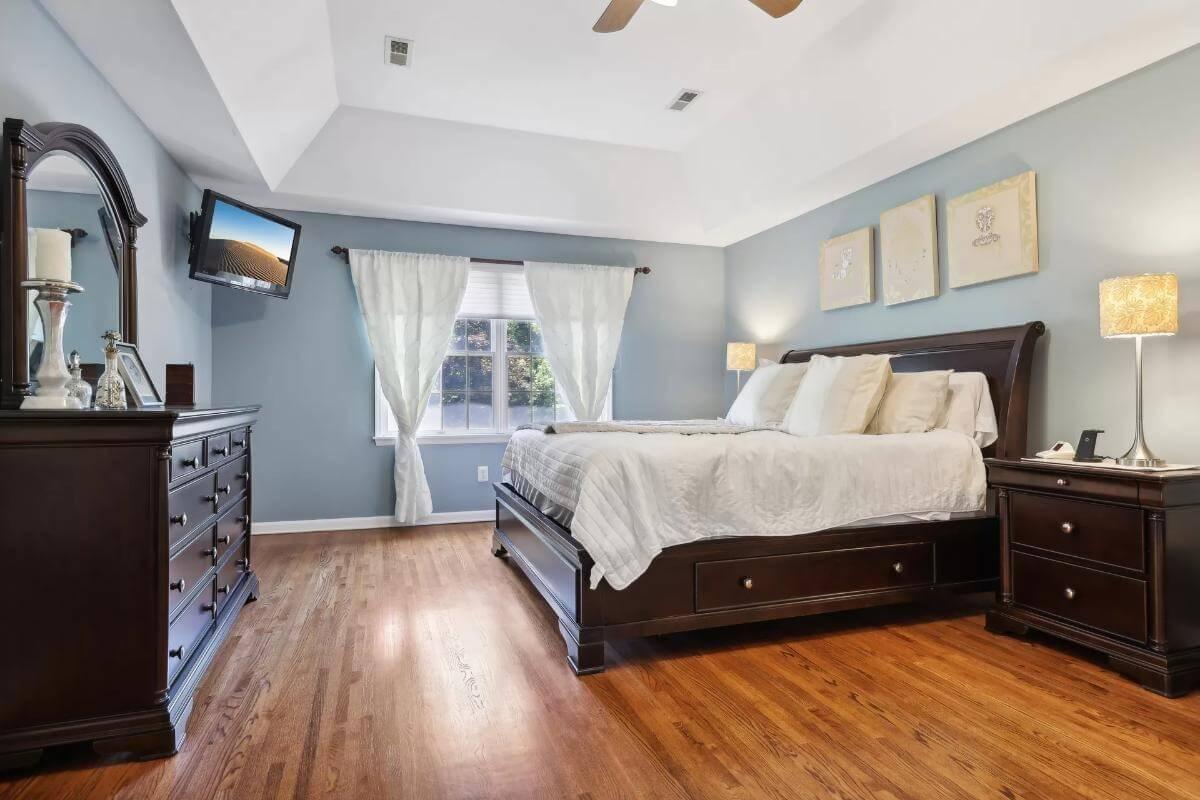 Serene Bedroom with Vaulted Ceilings and Rich Wood Furniture