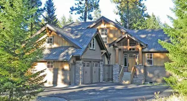 Craftsman Beauty Nestled in the Forest with Striking Stone Accents