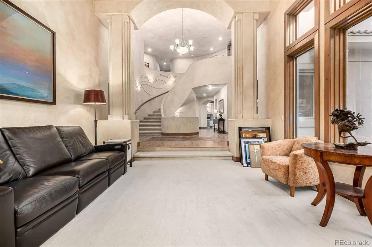 You Have to See This Curved Staircase Framed by Grand Archways