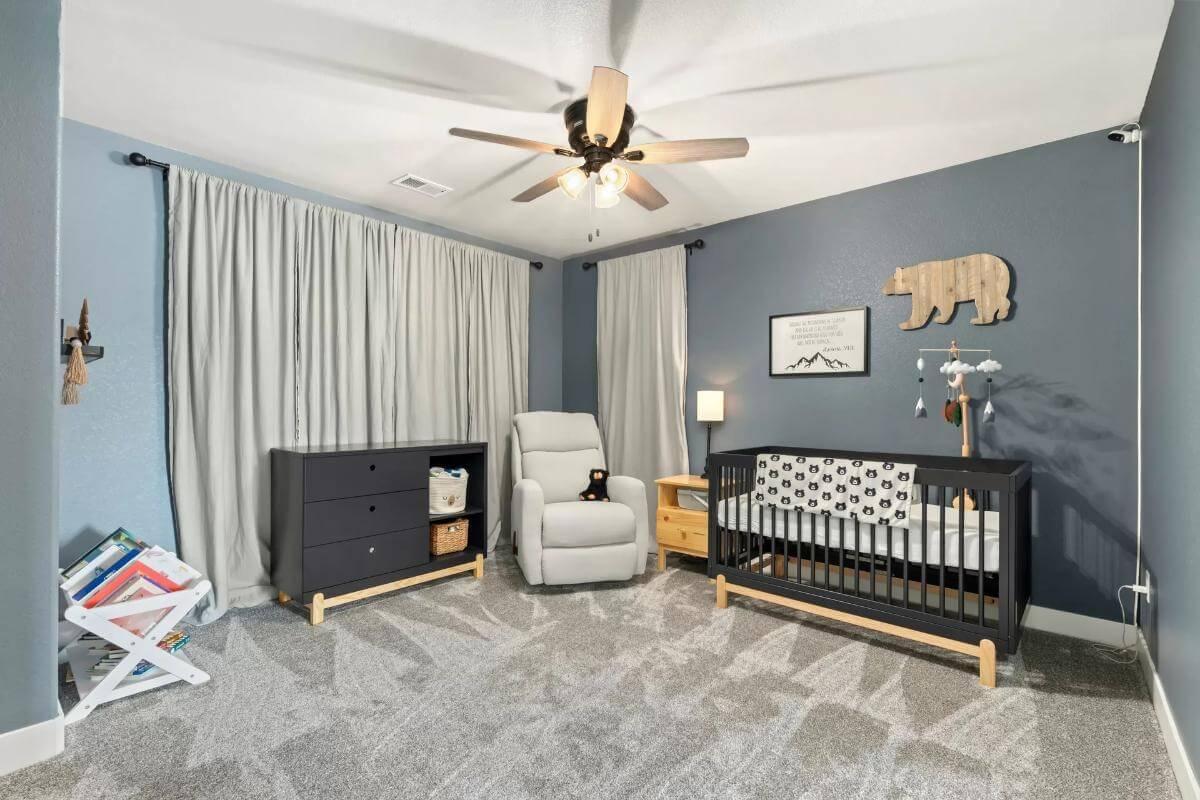 Charming Nursery with Playful Bear Decor and Soothing Blue Walls