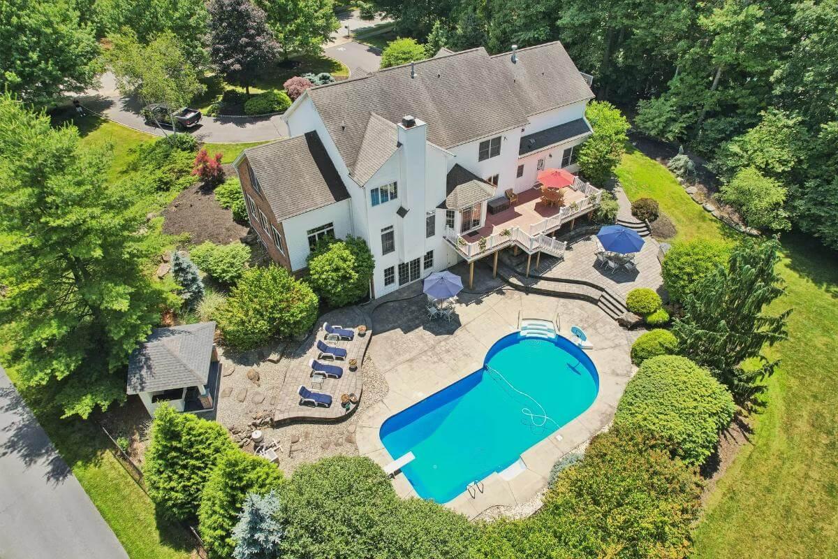Explore This Backyard Retreat with Poolside Relaxation and Elevated Deck