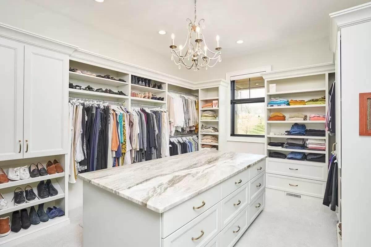 Luxury Walk-In Closet Featuring a Marble-Topped Island