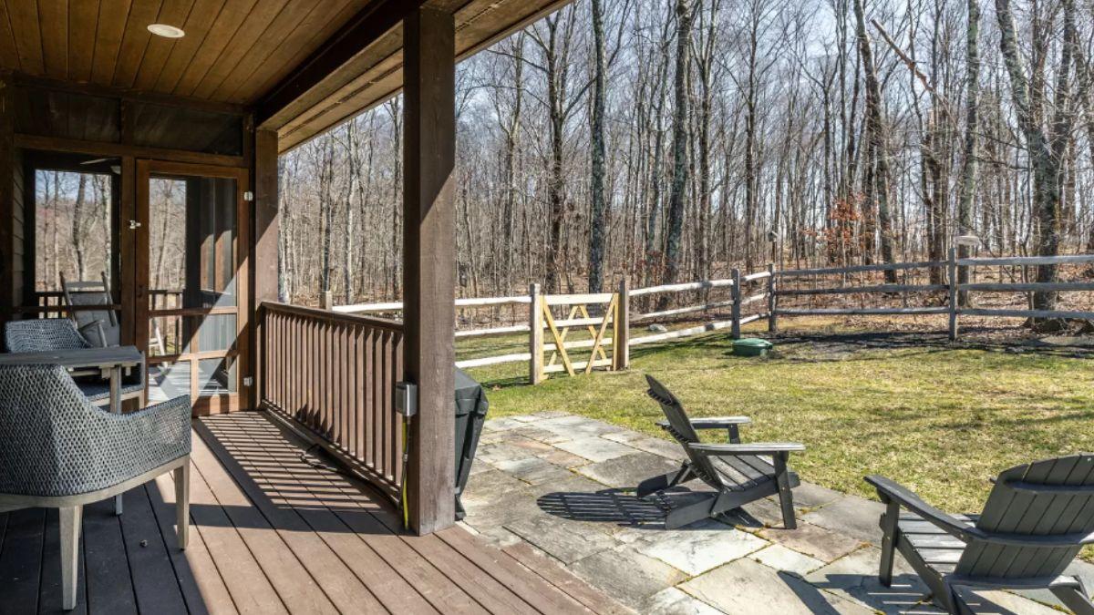 Enjoy the Seclusion of This Rustic Porch and Wooded Backyard
