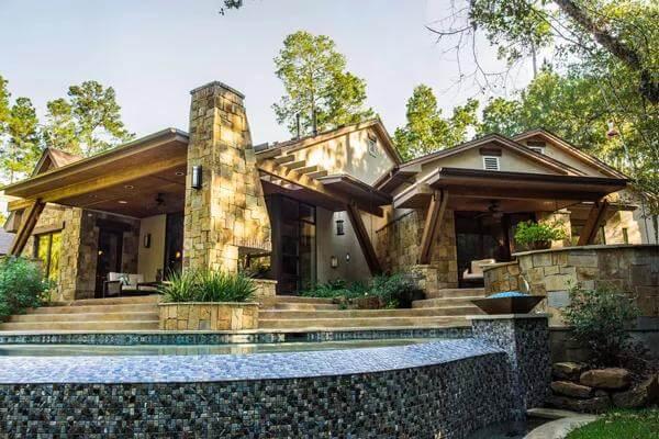 Wow, Check Out the Stone Fireplace and Waterfall Edge Pool in This Backyard Retreat