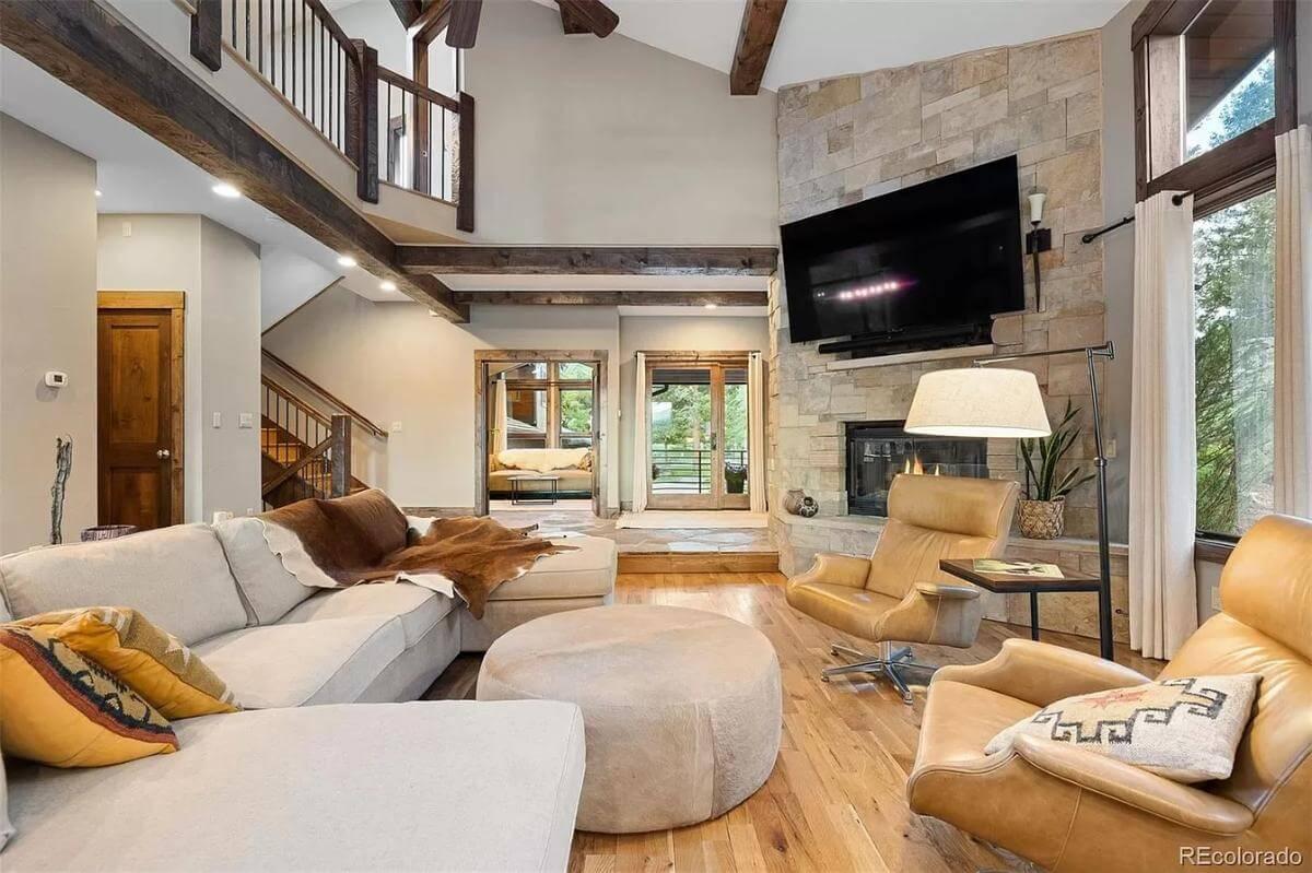 Spacious Living Room with Vaulted Ceilings and Stone Fireplace