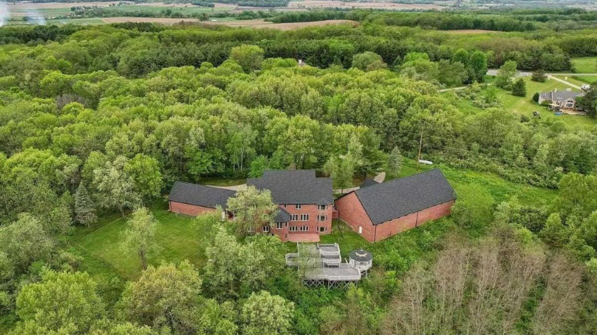 Aerial Perspective of Brick Manor in Lush Woodland