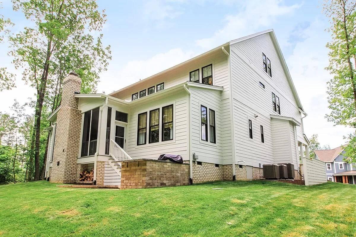 Notice the Brick Chimney Against the Crisp Siding on This Farmhouse