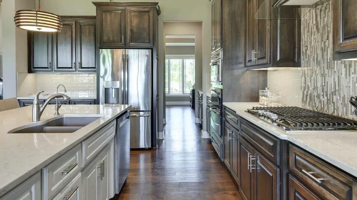 Check Out This Galley Kitchen with Dark Cabinets and a Mosaic Backsplash