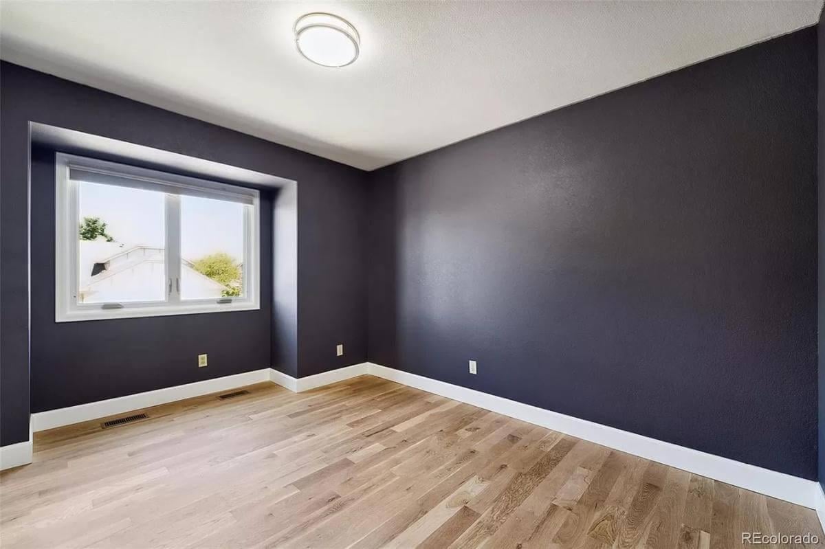 Deep Plum Accent Walls in an Unfurnished Room Offer Loads of Potential