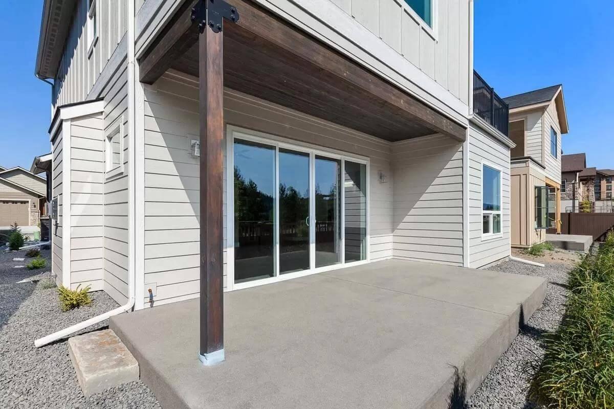 Enjoy the Seamless Transition from Indoor to Outdoor Living on This Covered Patio