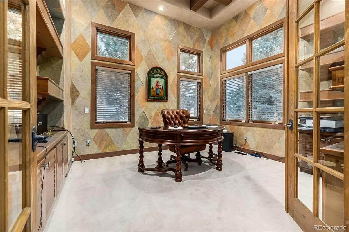 Distinctive Office Space with Bold Patterned Walls and a Rich Wood Desk