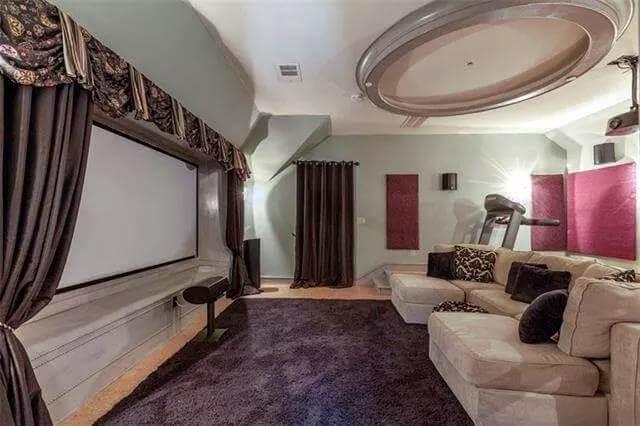 Cozy Home Theater with Plush Seating and Dramatic Curtains
