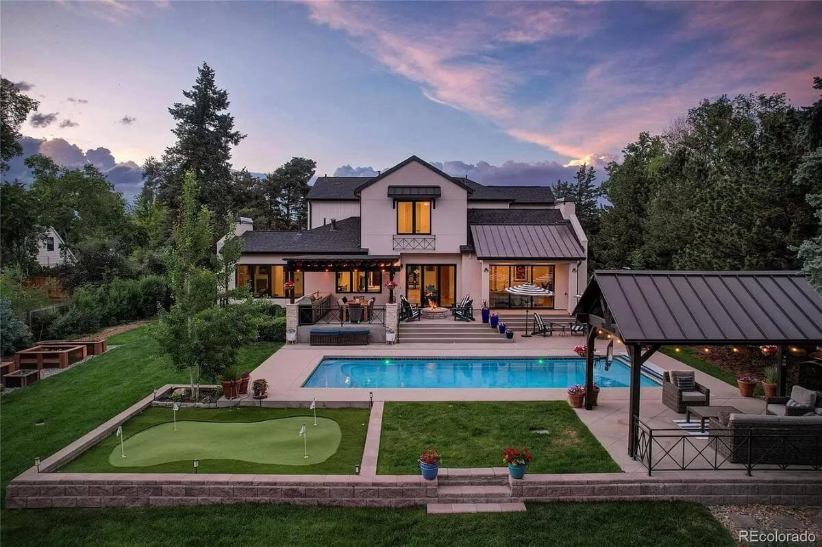 Take a Look at This Backyard with Poolside Lounge and Putting Green