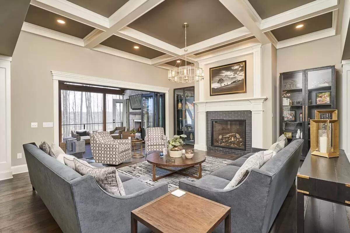 Elegant Living Room with a Coffered Ceiling and Cozy Fireplace