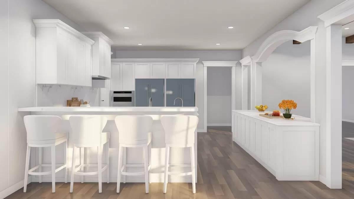 Admire the Arched Pass-Through in This Bright Kitchen Space