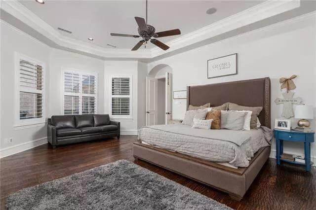 Notice the Tray Ceiling and Elegant Floor-Length Windows in This Bedroom Retreat