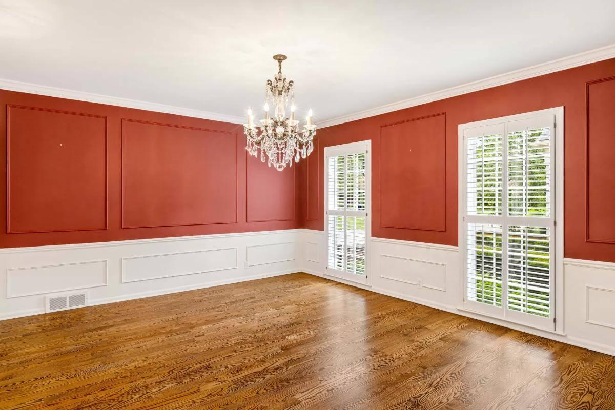 Classic Dining Room with Vibrant Red Walls and an Elegant Chandelier