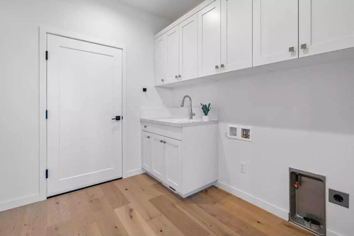 Efficient Laundry Space with Crisp White Cabinetry