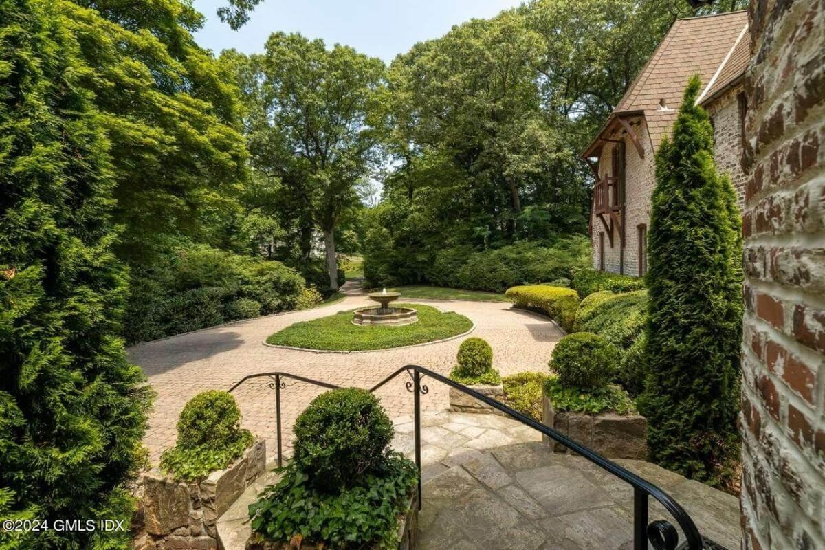 Admire the Timeless Beauty of This Circular Brick Drive with Center Fountain