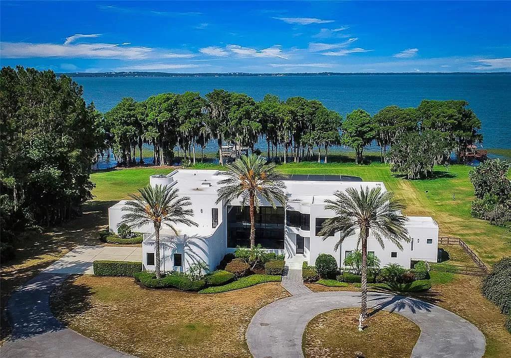 Stunning Waterfront Manor with Palm-Lined Driveway
