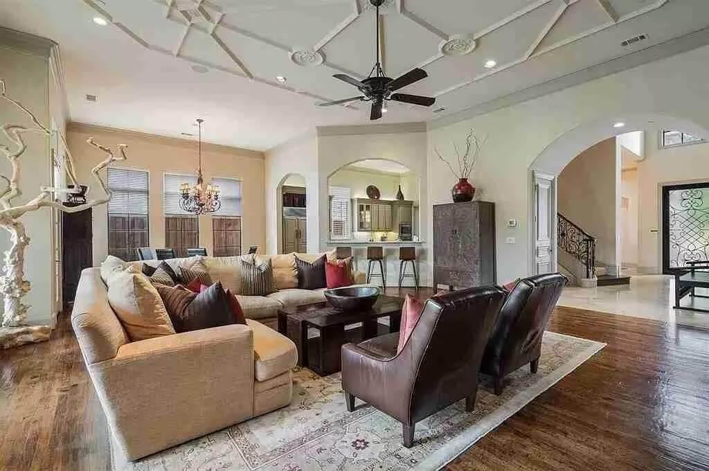 Spacious Living Area with Unique Ceiling Design and Cozy Seating