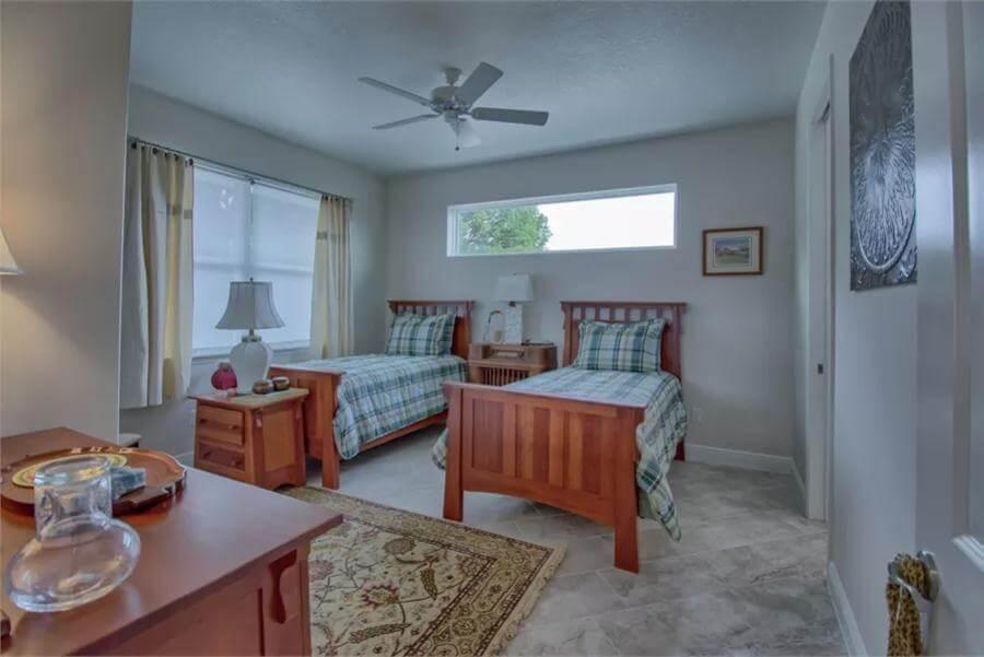 Twin Bedroom with Plaid Accents and Warm Tones