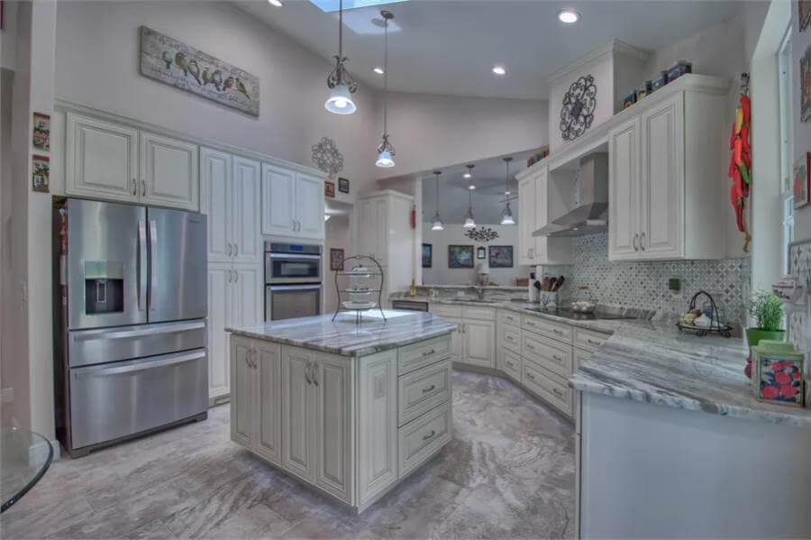 Modern Kitchen with a Skylight and Marble Island