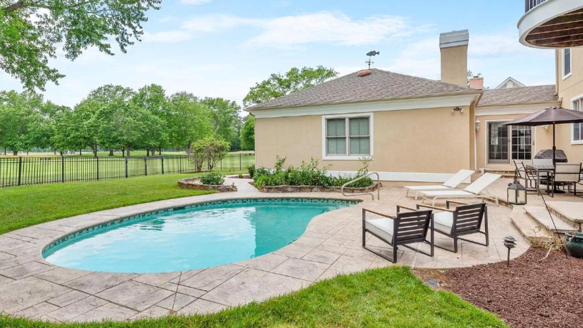 Backyard Escape with a Curved Pool and Terrace Seating